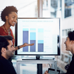 Three coworkers looking at computer screen