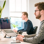 Two coworkers working on Power BI data